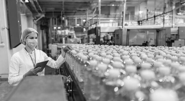SINGLE-IMAGE_food-and-beverage-woman-factory-water-bottles_may24