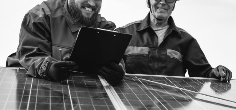 SOCIAL-GRAPHIC_two-male-engineers-on-solar-panels_jul24
