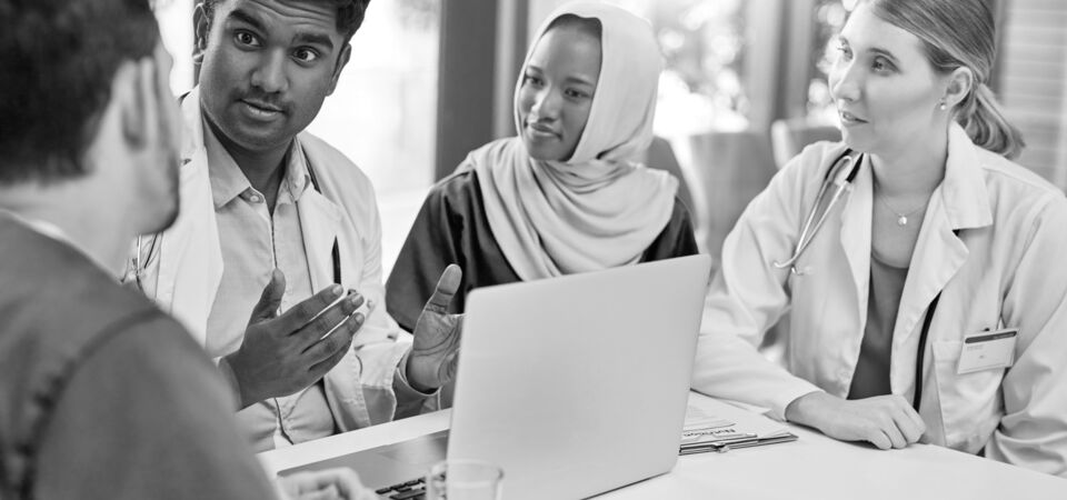 SINGLE-IMAGE_medical-staff-discuss-data-on-laptop_aug25