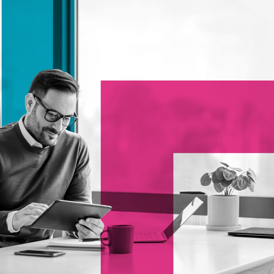 SINGLE-IMAGE_squares-man-with-tablet-at-desk-with-plant_feb24