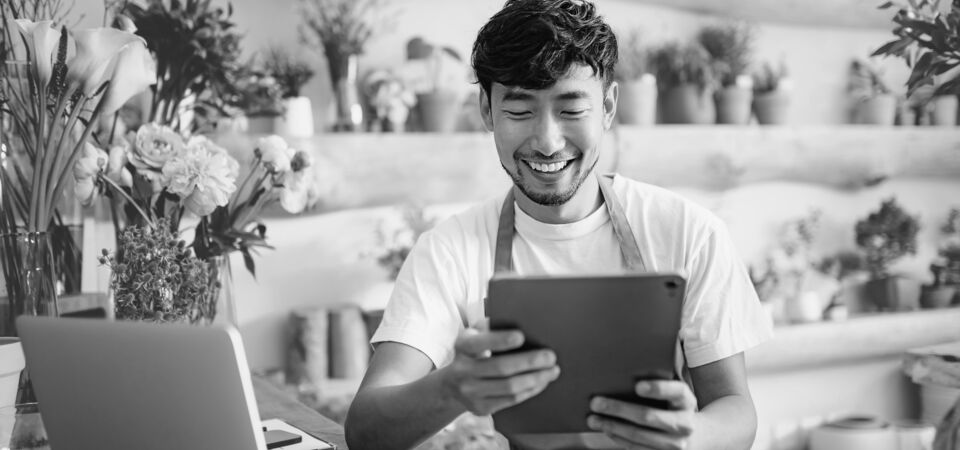 SINGLE-IMAGE_flower-shop-owner-checks-tablet_aug25