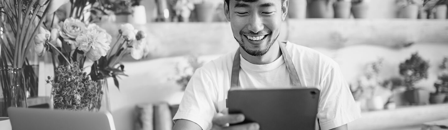 SINGLE-IMAGE_flower-shop-owner-checks-tablet_aug25