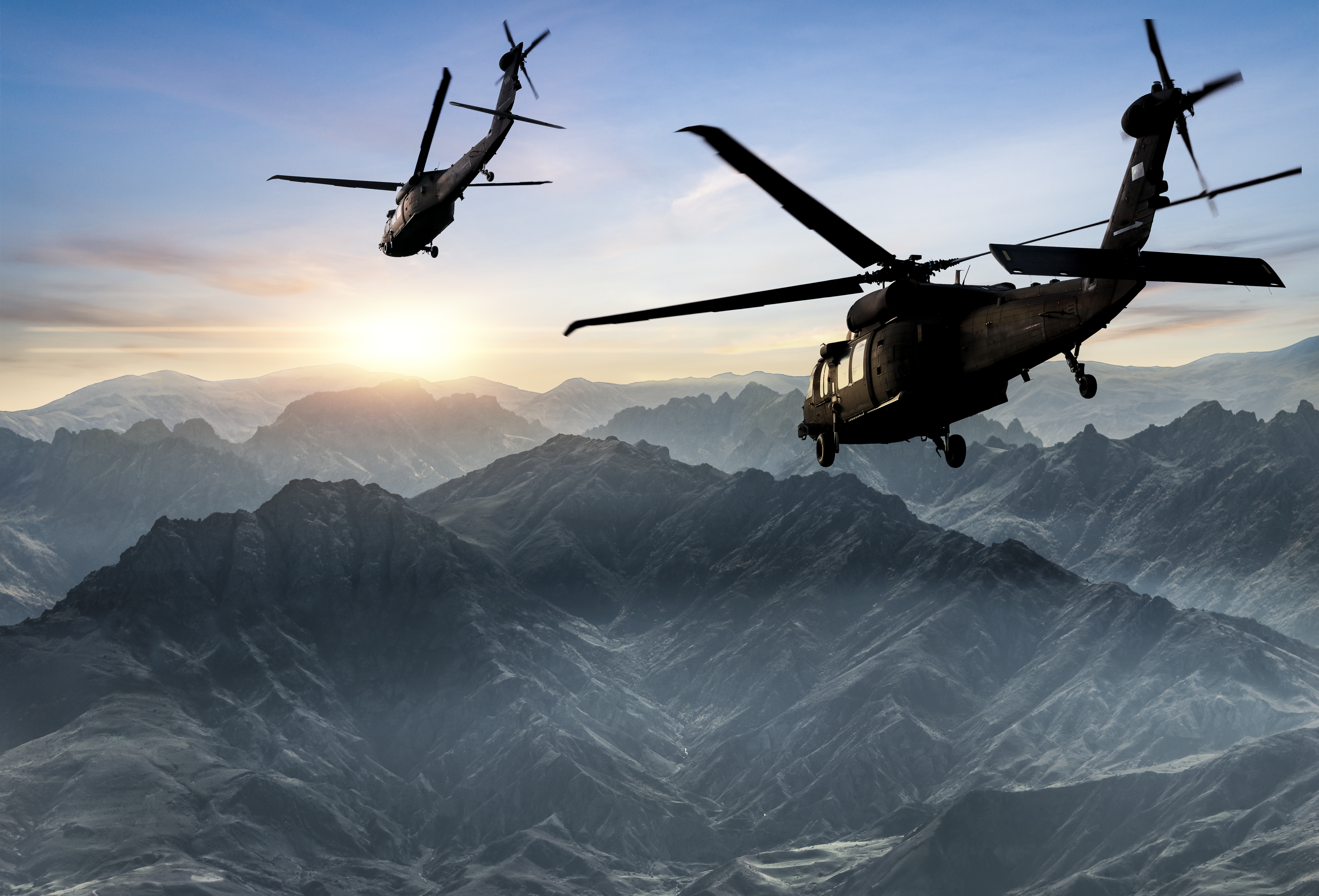 COLOUR-IMAGE_aerospace&defence-two-helicopters-flying-over-mountains_feb26
