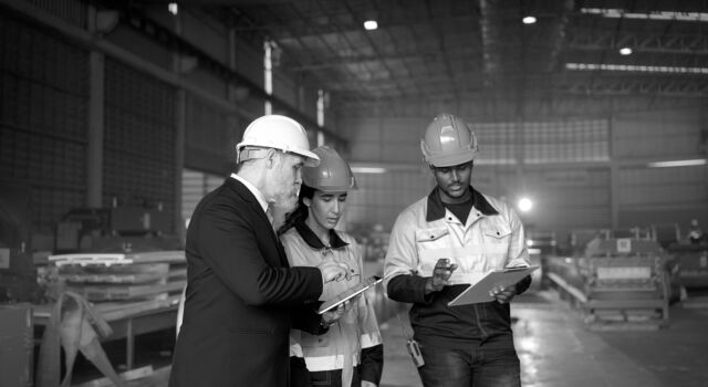 SINGLE-IMAGE_group-with-hard-hats-studying-tablet-and-clipboard_apr25