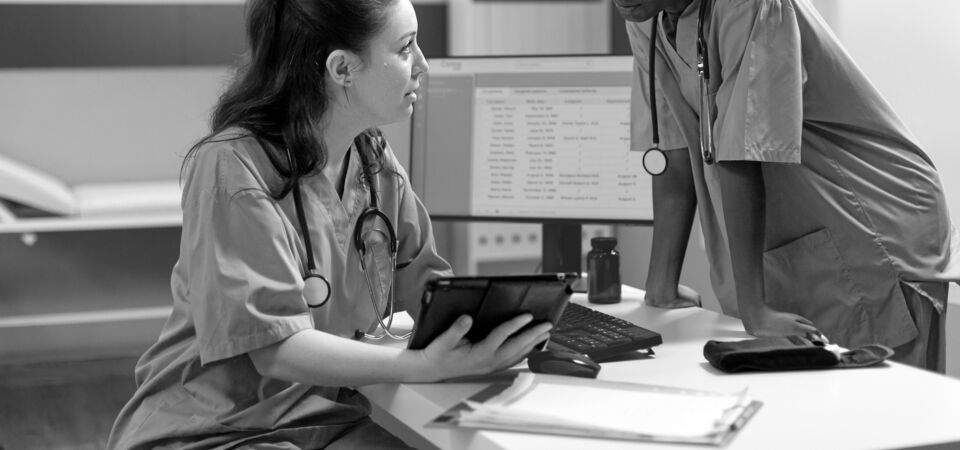 SINGLE-IMAGE_two-nurses-talking-over-tablet_sept24